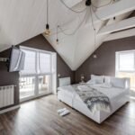 Stylish attic bedroom interior with modern furnishings and a cozy atmosphere.